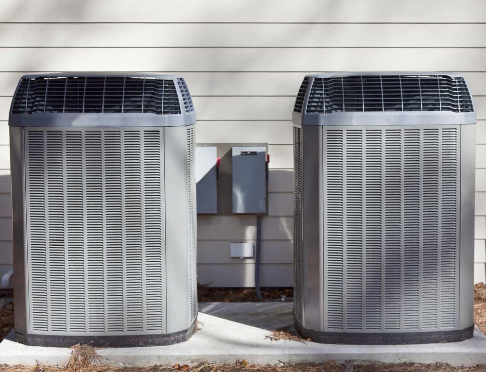Two large, gray outdoor heat pump units.