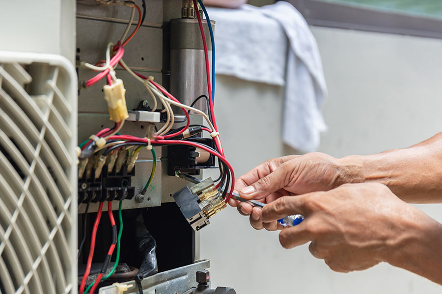 Technician repairing AC control board